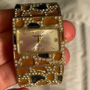 Gorgeous watch by POV. Clamp style, needs battery. New with plastic on watch